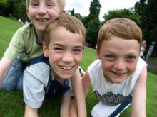 3 young boys in grass